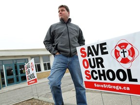 Mike Rohrer is photographed in front of St. Gregory School in Tecumseh on Thursday, April 3, 2014. Rohrer, along with several other parents, objects to a report that calls for the school to be closed.                         (TYLER BROWNBRIDGE/The Windsor Star)