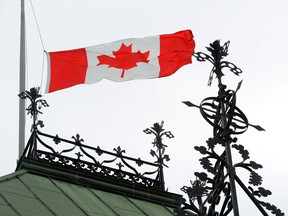 A Canadian Flag flies at half-mast on the East Block of Parliament Hill in Ottawa on Wednesday, April 23, 2014., in honour of the late Herb Gray, a former deputy Prime Minister who passed away Monday. (Sean Kilpatrick/The Canadian Press)