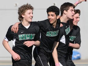 The Herman Green Griffins celebrate Joshua Schoberl's winning goal over Assumption College during the boys high school soccer game held at Alumni Field in Windsor, Ontario.   Herman defeated Assumption 1-0.(JASON KRYK/The Windsor Star)