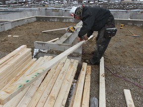 House framer Chris Gignac works on a new home in the Blue Heron Lake area of Windsor, Ont. on Tuesday, April 15, 2014. For housing market story. (DAN JANISSE/The Windsor Star)