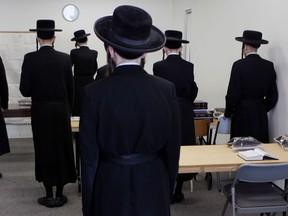 Male members of the Lev Tahor ultra-orthodox Jewish community attend prayers at their complex, in Chatham, Ont., Monday, Feb. 3, 2014. THE CANADIAN PRESS/Dave Chidley