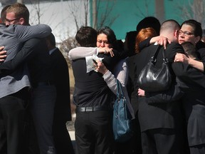 Funeral services were held for Katie Robson on Wednesday, April 9, 2014, in Windsor, Ont. The 20-year-old student was killed in a car accident Friday. Friends and family console each other at the conclusion of the ceremony.  (DAN JANISSE/The Windsor Star)