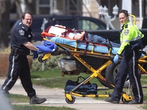 EMS paramedics take an 8-year old boy who was struck by a car on the 1300 block of George Ave. to the hospital, Sunday, April 20, 2014.  (DAX MELMER/The Windsor Star)