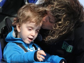 Michael Ginnasio, 3, gets a kiss from his mother, Sandra Ginnasio before the start of the Windsor Walk for Muscular Dystrophy at Assumption Park on Windsor's riverfront, Sunday, April 27, 2014.  Michael was born with Muscular Dystrophy. (DAX MELMER/The Windsor Star)