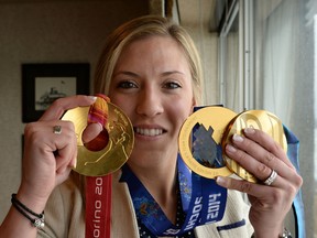 Meghan Agosta holds up her three Olympic gold medals. The hockey star took the 2014-15 season off to qualify for the Vancouver Police Department.
