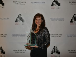 Mila Lucio, Vice President of A.P. Plasman holds the company`s Large Company of the Year award at the 2014 Business Excellence Awards.