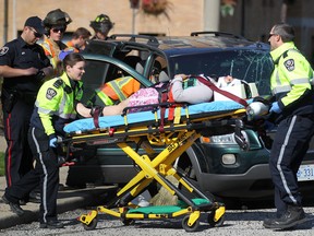 A woman is taken to hospital by EMS Paramedics after a two-car motor vehicle accident involving a Chevy Cavalier and a Pontiac Montana at the intersection of Giles Blvd. West and Dougall Ave., Sunday, April 27, 2014.  (DAX MELMER/The Windsor Star)