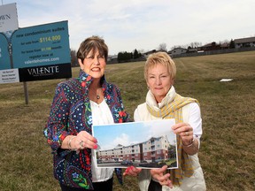 Real estate agents Ida Sproule, left, and Brenda Hawtin of Valente Real Estate pose in front of the site where a new condo development will be built in east Windsor, Ont. The location is on Wyandotte Ave. E. east of Lauzon Rd. (DAN JANISSE/The Windsor Star)