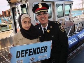 The Windsor Police Service unveiled the forceÕs new river patrol boat on Thursday, April 10, 2014, at the Lakeview Marina in Windsor, Ont. Omima Aniza, 10, won the naming contest for the boat with her entry "Defender". She poses with WPS Chief Al Frederick during the event. (DAN JANISSE/The Windsor Star)