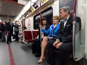 From left to right, Maria Augimeri, Toronto Transit Commission chair, Ontario Premier Kathleen Wynne, and Glen Murray, Minister of Infrastructure, ride the subway while en route to Wynne's speech at the Toronto Region Board of Trade in Toronto Monday, April 14, 2014. THE CANADIAN PRESS/Darren Calabrese
