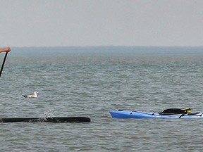 In this file photo, a couple of stand up paddle boarders and a kayaker enjoy the mild temperatures, Monday, April 21, 2014, near the Sand Point beach in Windsor, Ont. (DAN JANISSE/The Windsor Star)