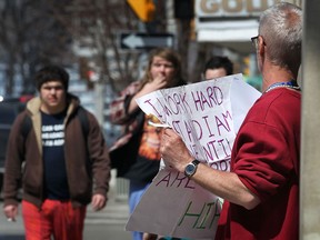 Downtown Windsor panhandler Paul Connolly (R) begs for change on Ouellette Avenue on April 1, 2014. Connolly said he lives in an apartment in the city. He said he hands out resumes and asks for employment while he panhandles. (Dan Janisse / The Windsor Star)