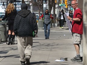 In this file photo, Paul Connolly (R), a downtown Windsor panhandler, begs on Ouellette Avenue on April 1, 2014. (Dan Janisse / The Windsor Star)
