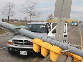 A traffic light pole rests on the hood of a Dodge Dakota at the intersection of Grand Marais Rd. East and Central Ave. Friday, April 18, 2014.  The driver of the vehicle was taken into custody on unrelated outstanding warrants.  No one was injured in the crash.  (DAX MELMER/The Windsor Star)