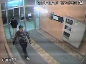 A surveillance photo released by Windsor police shows two suspects breaking into an apartment building on March 31, 2014. (HANDOUT/The Windsor Star)