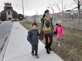 Joli Michalczuk and her kids River, 8, and Lyla, 6, are shown in front of St. Rose Catholic School on Thursday, April 10, 2014, in Windsor, Ont. Michalczuk is concerned about the closure of the old Riverside school.  (DAN JANISSE/The Windsor Star)