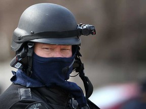 An officer with the Emergency Services Unit at the scene of a standoff with a stabbing suspect at the Pruefer Court apartment buildings, Sunday, April 13, 2014.  (DAX MELMER/The Windsor Star)