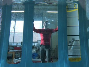 The University of Windsor is helping lead the development of offshore energy storage. The first such operation of its kind, off Toronto Island, was partly engineered by associate professor Rupp Carriveau pictured through a large water tank Tuesday, April 8, 2014, at a research lab at the Windsor, Ont. campus. (DAN JANISSE/The Windsor Star)