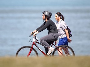 A cyclist and a rollerblader make their way along Windsor's riverfront on a beautiful sunny Easter Sunday, April 20, 2014.  (DAX MELMER/The Windsor Star)