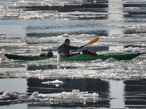 Paul Drouillard kayak's on the icy waters of the Detroit River on April 9, 2014.  (JASON KRYK/The Windsor Star)