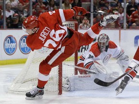Red Wings forwardTomas Jurco, left, jumps over Carolina Hurricanes goalie Cam Ward's stick during the second period in Detroit, Friday, April 11, 2014. (AP Photo/Carlos Osorio)
