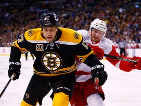 Boston's Milan Lucic, left, battles Detroit's Gustav Nyquist during Game 2 at TD Garden on April 20, 2014 in Boston, Massachusetts.  (Photo by Jared Wickerham/Getty Images)