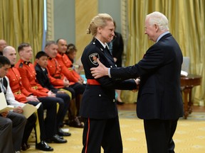 Governor General David Johnston presents the decoration of Bravery to Constable Susan McCormick of Windsor during a ceremony at Rideau Hall in Ottawa on Thursday. (Sean Kilpatrick / The Canadian Press)