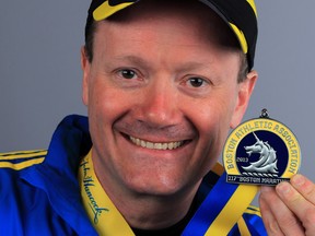 Boston Marathon runner George Drew holds his medal for finishing last year's race. (NICK BRANCACCIO / The Windsor Star)