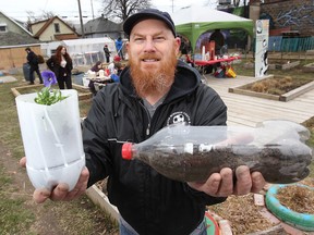 Steve Green of the Ford City Community Garden in Windsor, displays planters made from recycled plastic pop bottles. (DAN JANISSE / The Windsor Star)