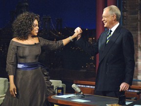 In this Dec. 1, 2005 file photo provided by CBS, Oprah Winfrey appears with David Letterman during a taping of on The Late Show with David Letterman, in New York. Following the interview, Dave escorted Oprah across 53rd street to the opening of her new Broadway Show The Color Purple. Letterman announced his retirement during a taping on Thursday, April 3, 2014. Although no specific date was announced he told the audience that he will leave his desk sometime in 2015. (AP Photo / Jeffrey R. Staab / CBS)
