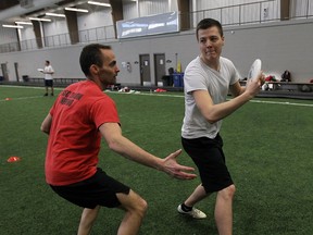 Dan Allaire, left, and Adam Marshall play Ultimate Frisbee at the Libro Credit Union Centre in Amherstburg recently. (TYLER BROWNBRIDGE / The Windsor Star)