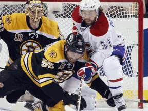 Boston's Johnny Boychuk, left, checks Montreal's David Desharnais during Game 5 of the playoffs at the TD Garden Saturday. (Photo by Bruce Bennett/Getty Images)
