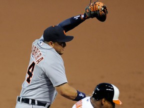 Baltimore's Delmon Young, right, is safe at first as Detroit's Miguel Cabrera jumps to catch the ball during the second inning Monday in Baltimore. (AP Photo/Nick Wass)
