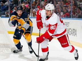Wings centre Stephen Weiss, right, is checked by Windsor native Luke Adam of the Sabres.(Photo by Jen Fuller/Getty Images)
