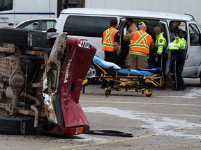 Essex-Windsor EMS paramedics, Windsor Police and Windsor firefighters assist injured motorists following a 2-vehicle collision on Huron Church Road and Girardot Street Thursday May 15, 2014.  A Toyota Tacoma and Ford passenger van ended up in the north bound lanes of Huron Church directly at the entrance of Assumption High School. (NICK BRANCACCIO/The Windsor Star)