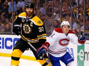 Boston's Zdeno Chara, left, is checked by Montreal's Brendan Gallagher in Game 7 Wednesday in Boston. (Photo by Jared Wickerham/Getty Images)