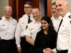 Windsor Police members pose for photos with a special guest, from left to right, Insp. Tom Crowley, Superintendent Mike Langlois, Insp. Brendan Dodd, Talbot Trail Public School sixth grader, Gauri Kumar, Insp. Rick Facciolio and Police Chief Al Frederick, at police headquarters, May 15. Kumar was chosen to be 'chief for the day' based on a letter she wrote as part of the Values Influences and Peers program at school. (Rick Dawes/The Windsor Star)
