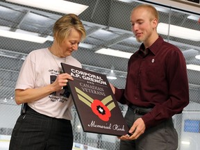 Theresa Charbonneau and Matthew Charbonneau hold a name plaque during the unveiling of the newly named Corporal AF Grenon and Canadian Veterans Memorial Arena at the WFCU Centre in Windsor on Thursday, May 15, 2014. (TYLER BROWNBRIDGE/The Windsor Star)