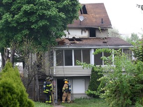 Windsor firefighters investigate the scene of a house fire at 516 Riverdale Ave. on Wednesday, May 14, 2014, that caused $350,000 in damages. (DAN JANISSE/The Windsor Star)