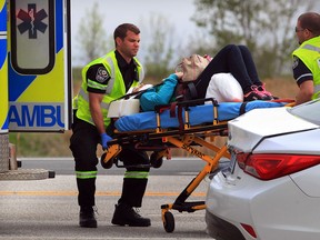 Essex-Windsor EMS paramedics assist an injured motorist following a 3-vehicle collision on County Road 22, east of Manning Road Wednesday May 14, 2014. Two persons were taken to hospital with non-life threatening injuries. West bound lanes were closed until the vehicles could be towed away.(NICK BRANCACCIO/The Windsor Star)