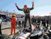 Will Power stands on his car after winning the first race of the IndyCar Chevrolet Detroit Belle Isle Grand Prix doubleheader in Detroit in 2013.