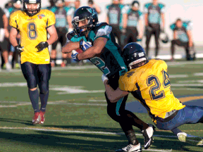 Essex's Chris Tannous, centre, carries the ball against the Soo Sabercats at Alumni Field Satudray. (JOEL BOYCE/The Windsor Star)