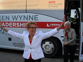 Premier Kathleen Wynne and her partner Jane Rounthwaite, right, makes a stop at the headquarters of MPP Teresa Piruzza Tuesday May 20, 2014.  Hundreds of supporters jammed the small office to hear and see Premier Wynne.   (NICK BRANCACCIO/The Windsor Star)