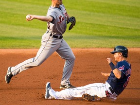 Tigers shortstop Danny Worth, left, throws out David Murphy at first base after making the force out against Lonnie Chisenhall of the Cleveland Indians Tuesday at Progressive Field in Cleveland. (Photo by Jason Miller/Getty Images)