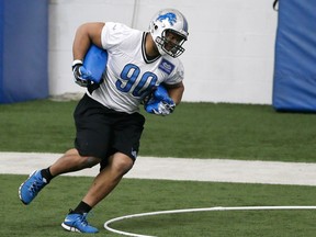 Lions defensive tackle Ndamukong Suh runs through drills during organized team activities at the team's training camp facility in Allen Park, Mich. (AP Photo/Carlos Osorio)