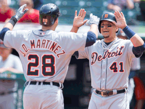 Detroit's  J.D. Martinez, left, and Victor Martinez celebrate after J.D. Martinez hit a two-run homer during the first inning against the Cleveland Indians at Progressive Field Wednesday. (Photo by Jason Miller/Getty Images)