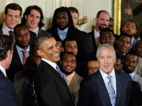 President Barack Obama shares a laugh with Seattle coach Pete Carroll during a ceremony in the East Room of the White House in Washington Wednesday. LaSalle's Luke Willson is in the back row, second from left. (AP Photo/Susan Walsh)