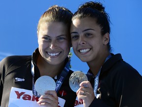 Silver medallists Roseline Filion and Meaghan Benfeito pose with their medals at the FINA World Championships in Barcelona. (AFP/Getty Images)