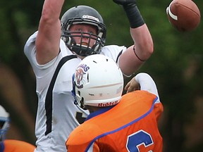 AKO's John Moynahan, top, breaks up a pass from the St. Leonard quarterback at Windsor Stadium. (DAX MELMER/The Windsor Star)