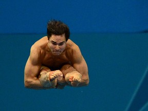 Alexandre Despatie competes in the men's 3-metre springboard semifinals during the diving event at the London 2012 Olympic Games on August 7, 2012 in London. (MARTIN BUREAU/AFP/GettyImages)